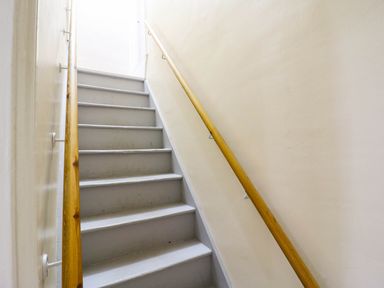 A staircase with a handrail at Dover Retreat