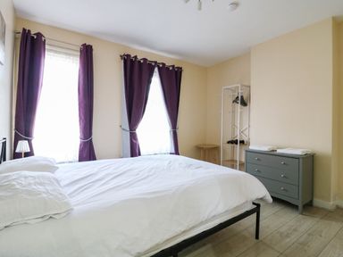 A bedroom with a bed and dresser at Dover Retreat