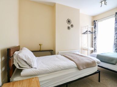 A bedroom with two beds and a nightstand at Dover Retreat