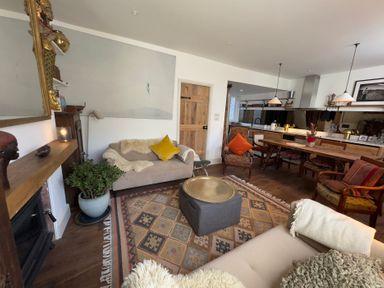 A living room with a sofa and coffee table at Bohemian Beach Cottage in Bournemouth