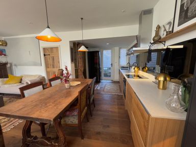 A kitchen with a dining table and chairs at Bohemian Beach Cottage in Bournemouth