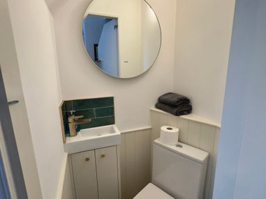 A bathroom with a sink and a toilet at Bohemian Beach Cottage in Bournemouth