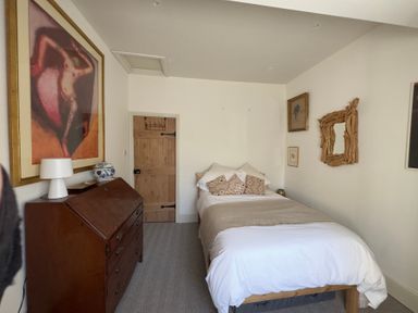 A bedroom with a bed and furniture at Bohemian Beach Cottage in Bournemouth