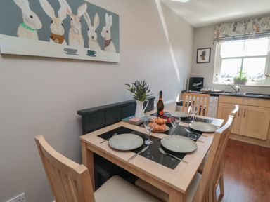 A dining room with a table set for breakfast at Stanton House - Abbey View, Flat 3