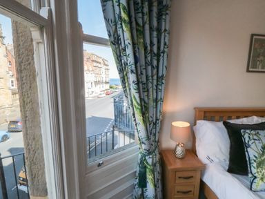 A bedroom with a window and bed at Stanton House - Abbey View, Flat 3