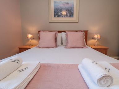 A bedroom with a double bed and bedside lamps at Stanton House - Abbey View, Flat 3