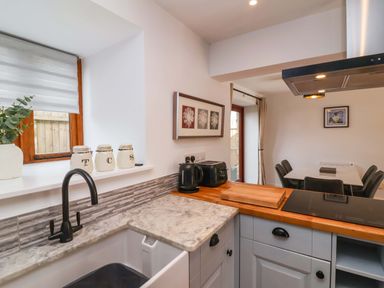 A kitchen with a sink and appliances at Butterfly Days in Bideford