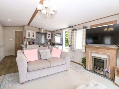 A living room with a sofa and television at 17 Castle Walk Great Yarmouth