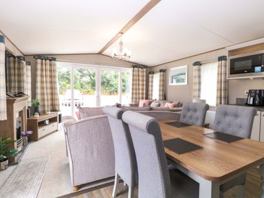 A living room with a dining area and television at 17 Castle Walk in Great Yarmouth