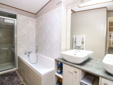 A bathroom with a bathtub and a sink at 17 Castle Walk in Great Yarmouth