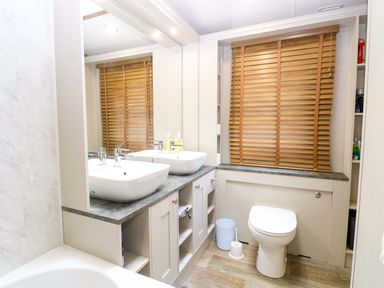 A bathroom with sinks and a toilet at 17 Castle Walk in Great Yarmouth