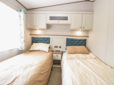 A bedroom with two beds and cabinets at 17 Castle Walk in Great Yarmouth