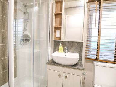A bathroom with a shower and sink at 17 Castle Walk in Great Yarmouth