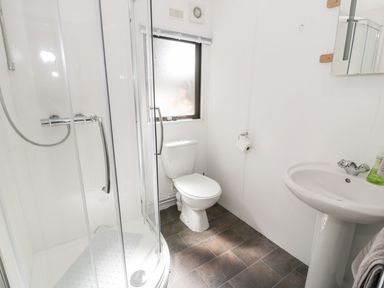 A bathroom with a shower, toilet, and sink at Springtime Lodge in Rhyd-y-Foel near Abergele