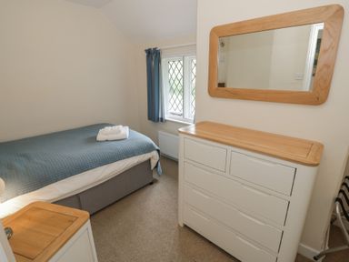 A bedroom with a bed and furniture at Hillside Cottage