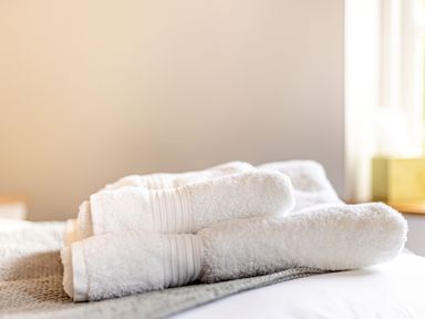 White folded towels on a bed at The Cider Mill in Westhope near Leominster