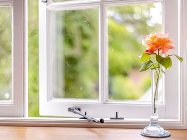 A window with a single rose in a glass vase on the sill at The Cider Mill in Westhope near Leominster