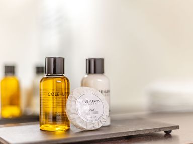 A close up of shampoo lotion and soap bottles on a tray at The Cider Mill in Westhope near Leominster