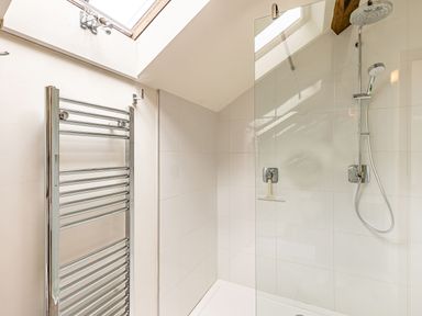 A bathroom with a walk-in shower and chrome towel radiator at The Cider Mill in Westhope near Leominster