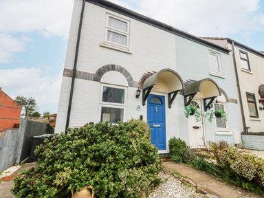 A house with a blue front door and pathway at 23 The Maltings in Weymouth