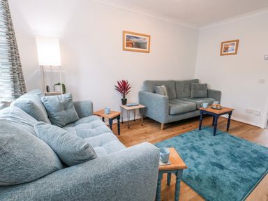 A living room with sofas and a side table at 23 The Maltings in Weymouth