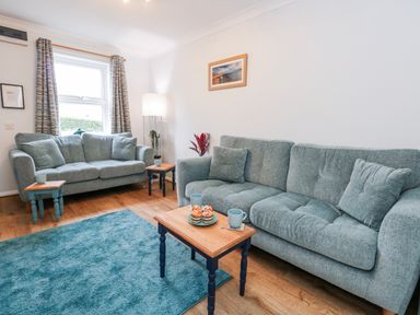 A living room with two sofas and a table at 23 The Maltings in Weymouth