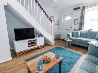 A living room with a sofa and television at 23 The Maltings Weymouth