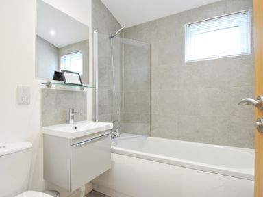 A bathroom with a bathtub and a sink at 3 Meadow Retreat in Liskeard