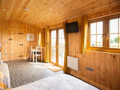 A glamping hut interior with wooden features at Head For the Hills Glamping - Skylark Shepherd's Hut