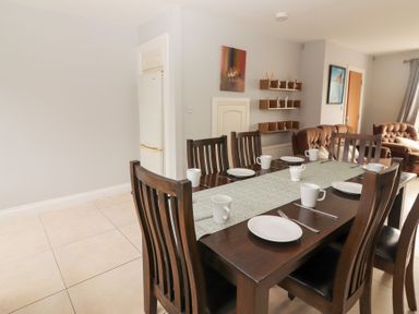 A dining room with a table set for a meal at 1 Windermere Kinvarra
