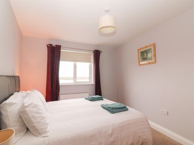 A bedroom with a bed and window at 1 Windermere in Kinvarra