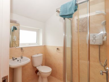 A bathroom with a shower, sink, and toilet at 1 Windermere in Kinvarra