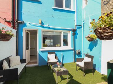 An outdoor seating area with chairs and a table at 1 Windermere in Kinvara, County Galway