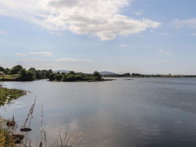 A view of a river with trees and land along the shore at 1 Windermere in Kinvara, County Galway