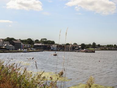 A view of a river with houses and boats at 1 Windermere in Kinvara, County Galway