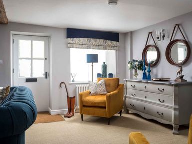 A living room featuring a yellow chair and a window at Lavender Cottage (Stow-on-the-Wold) Cheltenham