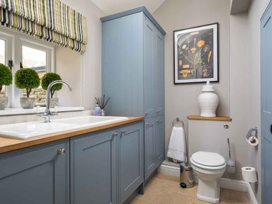A bathroom with a sink, toilet, and cabinets at Lavender Cottage (Stow-on-the-Wold) Cheltenham