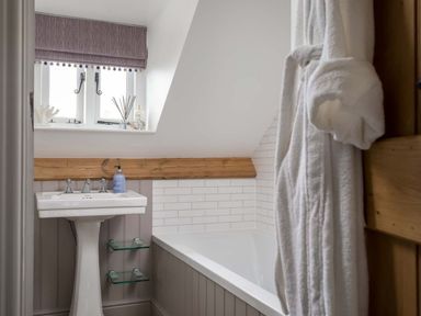 A bathroom with a sink and bathtub at Lavender Cottage (Stow-on-the-Wold) Cheltenham
