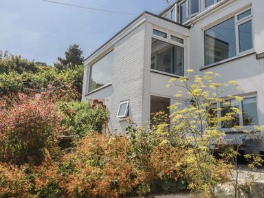 A house with windows and a garden at Kiln Cottage in Golant near Tywardreath