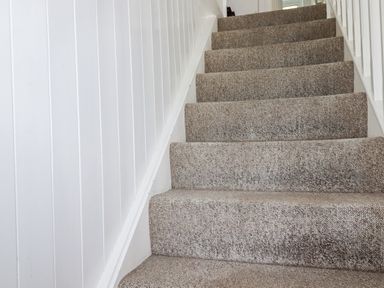 A staircase with carpet and white walls at Kiln Cottage Golant near Tywardreath