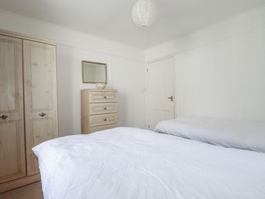 A bedroom with a bed and furniture at Kiln Cottage Golant near Tywardreath