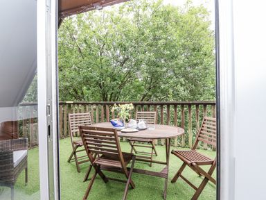 A balcony with a table and chairs at Valley Lodge 20 in Callington