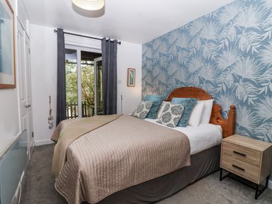 A bedroom with a bed and a window at Valley Lodge 20 in Callington
