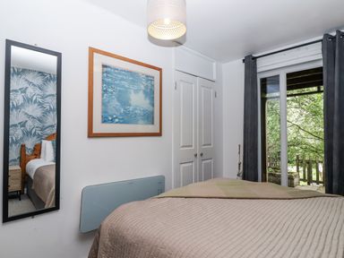 A bedroom with a bed and a window at Valley Lodge 20 Callington