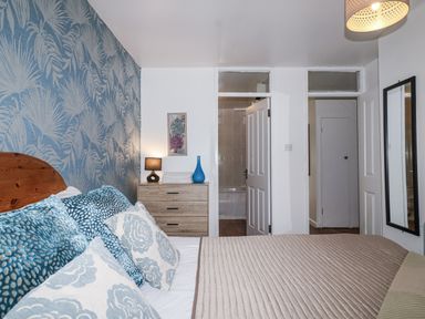 A bedroom with a bed and dresser at Valley Lodge 20 Callington