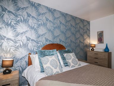 A bedroom with a bed and decorative pillows at Valley Lodge 20 in Callington