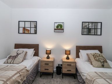 A bedroom with two beds and nightstands at Valley Lodge 20 Callington