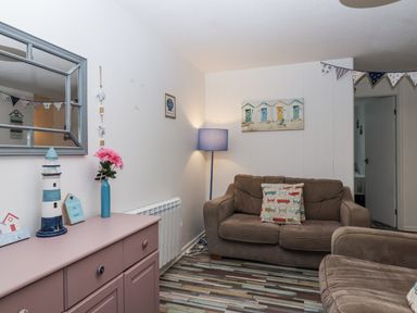 A living room with a sofa and decorative objects at Manorcombe 21 Honicombe Holiday Village near Gunnislake