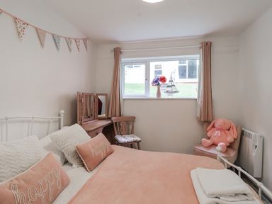 A bedroom with a bed and a window at Manorcombe 21 Honicombe Holiday Village near Gunnislake