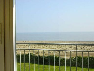 A view of the beach and sea from behind a balcony railing at Seascape in Kessingland near Lowestoft